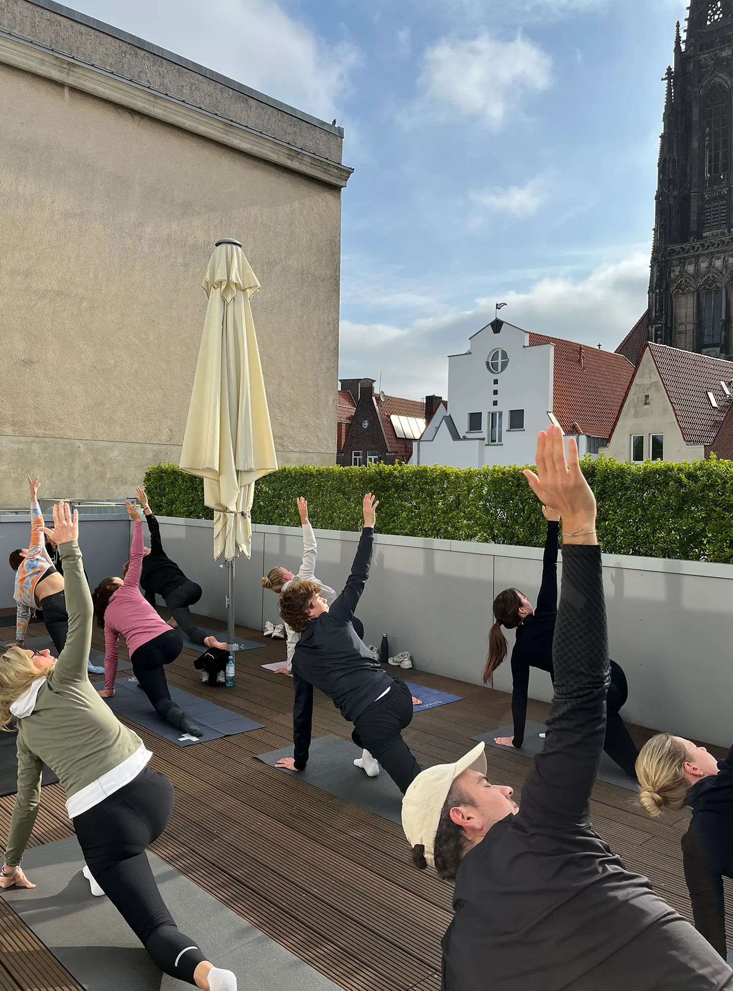 Das Bild zeigt eine Yoga Stunde auf der Dachterrasse